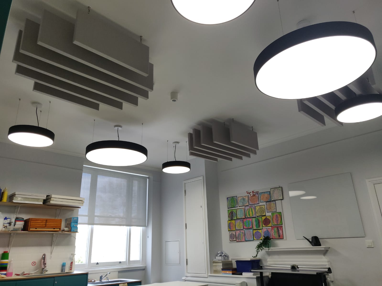 Acoustic ceiling baffle panels in a classroom
