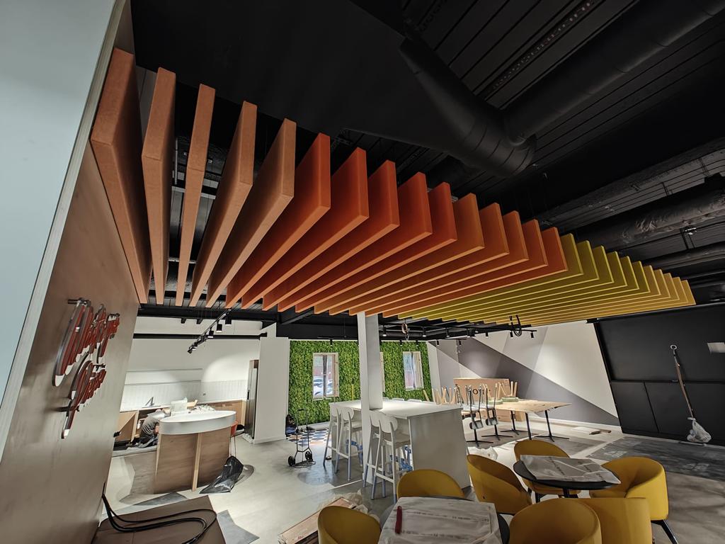 Acoustic ceiling panels suspended in an office break room