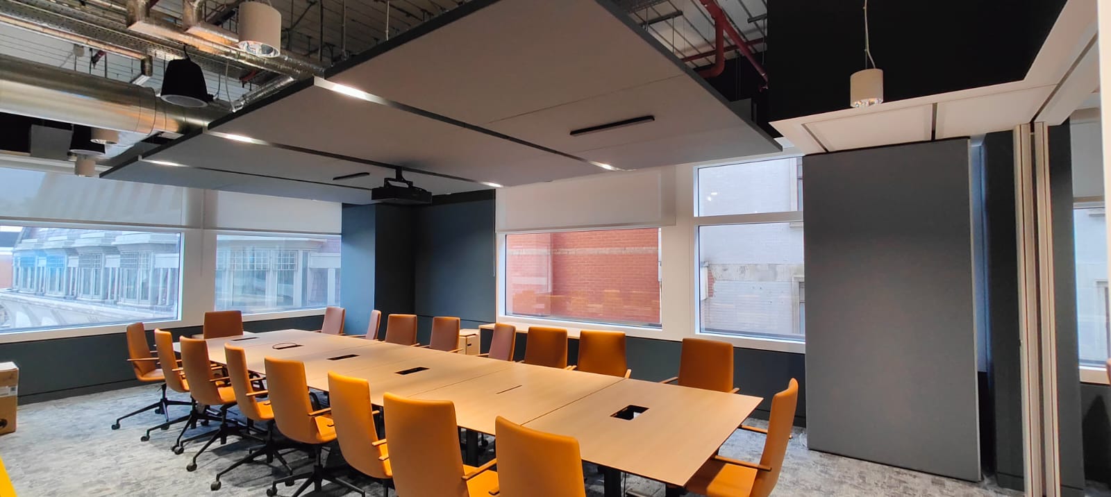 Acoustic ceiling panels suspended in a meeting room